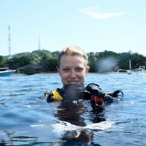 Photo of Sara in the ocean wearing diving gear.